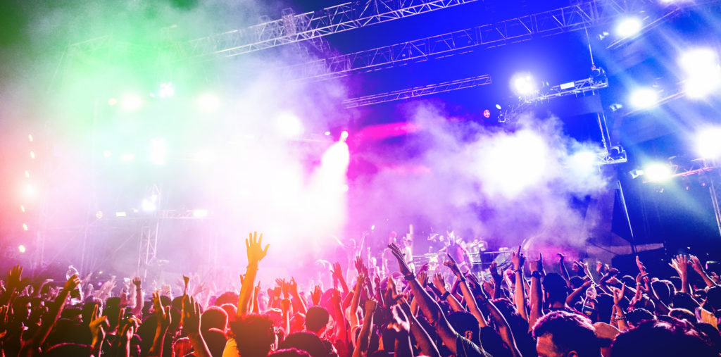 Young people dancing and having fun in summer festival party outdoor